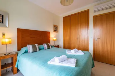 a bedroom with a bed with two towels on it at Vista das Ondas by Algarneto in Albufeira