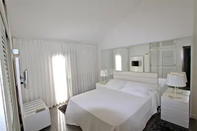 a white bedroom with a white bed and a window at Marina Parque 83 - Clever Details in Vilamoura