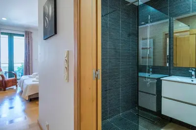 a bathroom with a glass shower with a sink at Marina Vilamoura - Aquamar 401- Modern Apartment in Vilamoura