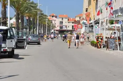 a group of people walking down a busy city street at Marina Vilamoura - Aquamar 401- Modern Apartment in Vilamoura