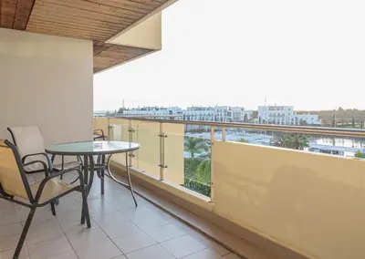 a balcony with a table and chairs and a view at Marina Vilamoura - Aquamar 309 By Vilamoura Sun in Vilamoura