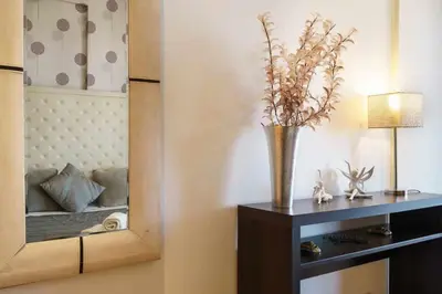a bedroom with a bed with a flower on the wall at Marina Vilamoura - Aquamar 403 by Vilamoura Sun in Vilamoura