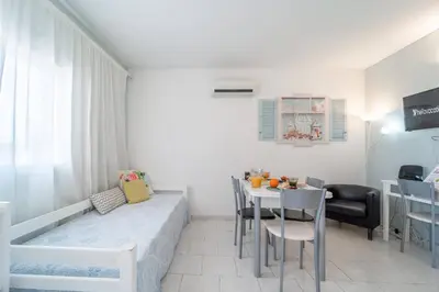 a living room with a bed and a table at Lena`s Beach House by HelloVacations in Albufeira