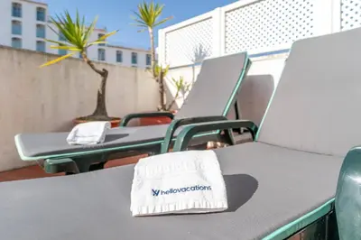 a table with chairs and a napkin on top of it at Lena`s Beach House by HelloVacations in Albufeira