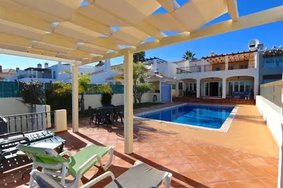 a house with a swimming pool and a patio at Villa Heloise 139 - Clever Details in Vilamoura