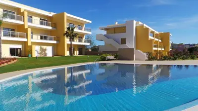 a large swimming pool in front of a building at Algarve 