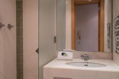 a bathroom with a sink and a mirror at BmyGuest - Quinta do Lago Lounge Apartment in Almancil