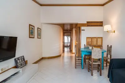 a living room with a blue table and chairs at BmyGuest - Quinta do Lago Lounge Apartment in Almancil
