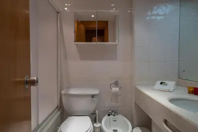 a bathroom with a white toilet and a sink at BmyGuest - Quinta do Lago Lounge Apartment in Almancil