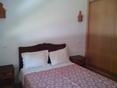 a bedroom with a bed with two pillows at Albufeira 1 bedroom apartment 5 min from Falesia beach and close to center E in Albufeira