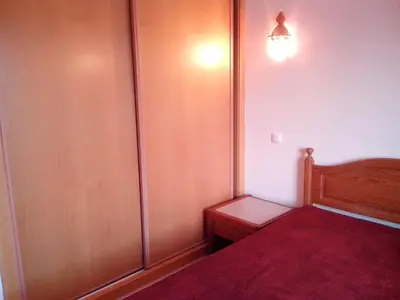 a small bedroom with a bed with a red blanket at Albufeira 2 bedroom apartment 5 min from Falesia beach and close to center B in Albufeira