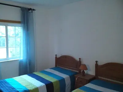 a bedroom with two beds and a window at Albufeira 2 bedroom apartment 5 min from Falesia beach and close to center B in Albufeira