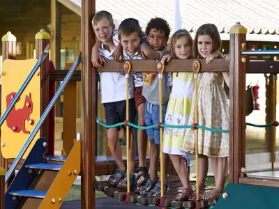 a group of children standing on a playground at Four Seasons Vilamoura in Vilamoura
