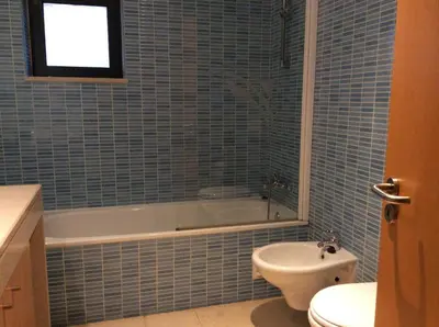 a bathroom with a tub and a toilet and a sink at Corcovada in Albufeira