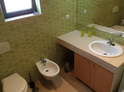 a bathroom with a toilet and a sink at Corcovada in Albufeira