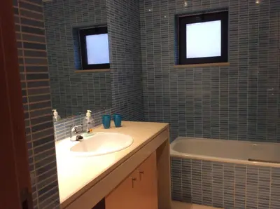 a bathroom with a sink and a bath tub at Corcovada in Albufeira
