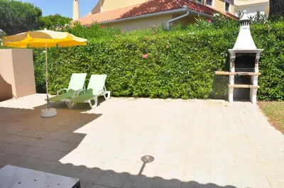 a swimming pool in front of a house at Stylish and well-equipped, private pool, close to amenities, free AC Wifi in Quarteira