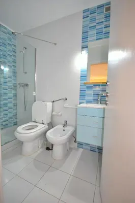 a bathroom with a toilet and a sink and a shower at Stylish and well-equipped, private pool, close to amenities, free AC Wifi in Quarteira