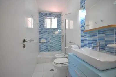 a bathroom with a toilet and a shower and a sink at Stylish and well-equipped, private pool, close to amenities, free AC Wifi in Quarteira