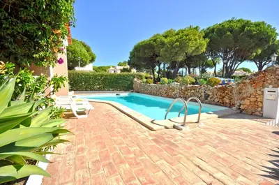 a living room with a couch and a table at Stylish and well-equipped, private pool, close to amenities, free AC Wifi in Quarteira
