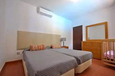 a living room with a couch and a tv at Perfect Retreat Overlooking Pinhal Golf Course, Private pool, Off-street parking in Loulé
