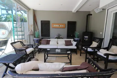 a living room with couches and tables and chairs at Villa Bonito 56 - Clever Details in Vilamoura