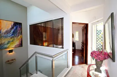 a glass staircase in a house with a painting at Villa Bonito 56 - Clever Details in Vilamoura