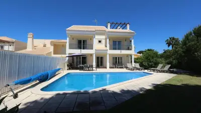 a large white house with a large yard at Villa Amendoeira 4 - Clever Details in Vilamoura