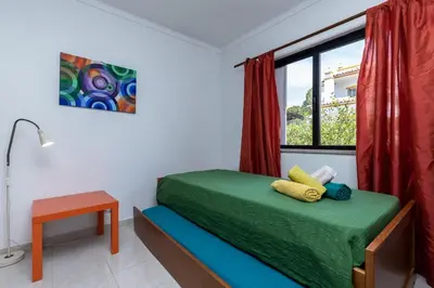 a bedroom with a bed and a window at Akisol Olhos de Agua Pine II in Albufeira
