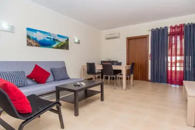 a living room with a couch and a table at Akisol Albufeira Guia II in Guia