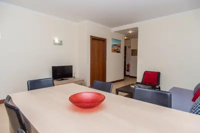a red bowl on a table in a room at Akisol Albufeira Guia II in Guia