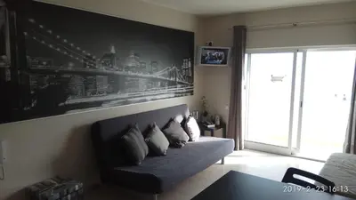 a living room with a couch with pillows on it at Apartamento de Praia - Albufeira in Albufeira