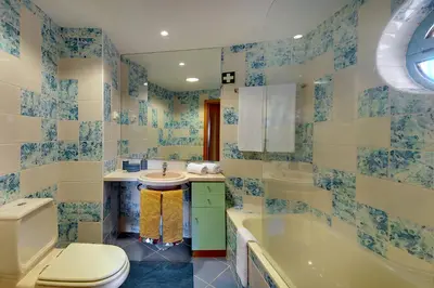 a bathroom with a toilet and a tub and a sink at Marina Bay Residence in Albufeira