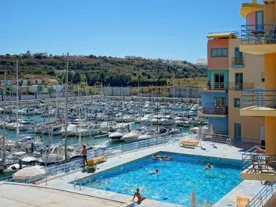 a view of a marina from the balcony of a hotel at Marina Bay Residence in Albufeira