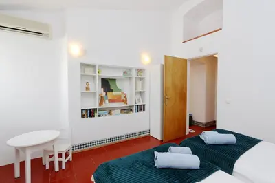 two beds in a room with a table and a desk at Villa Molgard 61 - Clever Details in Vilamoura