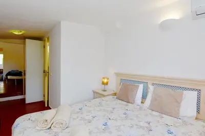 a bedroom with a bed with two towels on it at Villa Molgard 61 - Clever Details in Vilamoura
