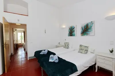 a bedroom with two beds with shoes on them at Villa Molgard 61 - Clever Details in Vilamoura