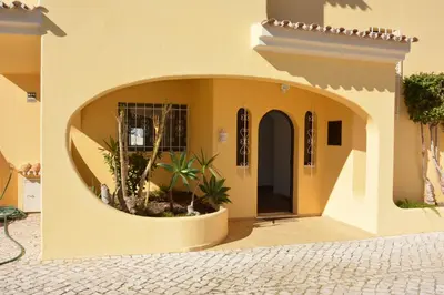 a building with a circular entrance with plants in it at Villa Paraiso - 4 Bedrooms and pool in Albufeira
