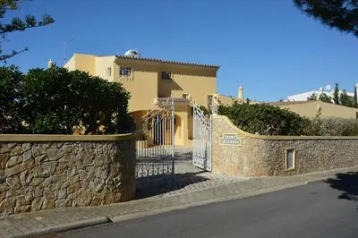 a gate to a house with a stone wall at Villa Paraiso - 4 Bedrooms and pool in Albufeira