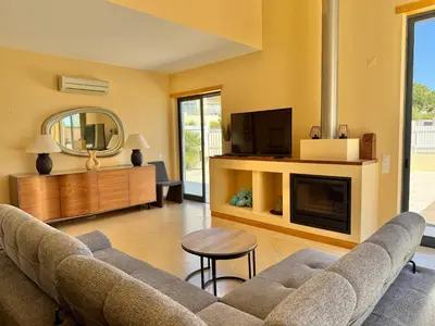a wooden table and chairs on a patio at Villa Corcovada Vitória with private pool in Albufeira