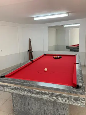 a red pool table with a ball on it at Algarvila in Vilamoura