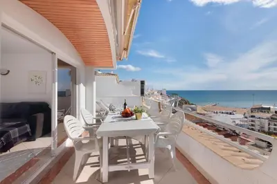 a balcony with a table and chairs and the ocean at Apartamento Varandas do Mar, Praia dos Pescadores, Albufeira in Albufeira