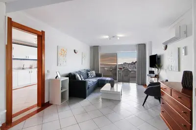 a living room with a couch and a table at Apartamento Varandas do Mar, Praia dos Pescadores, Albufeira in Albufeira