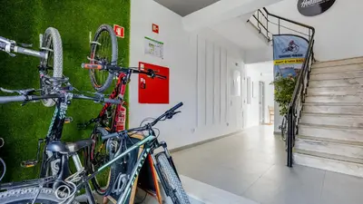 a hallway with two bikes hanging on a wall at Hostellicious in Faro