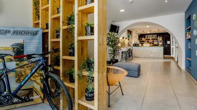 a bike parked in a room with shelves at Hostellicious in Faro