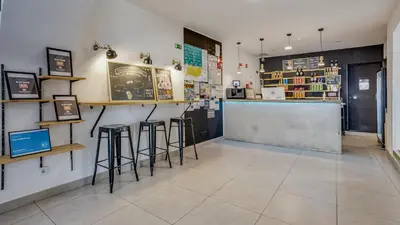 a bar in a store with stools in a room at Hostellicious in Faro