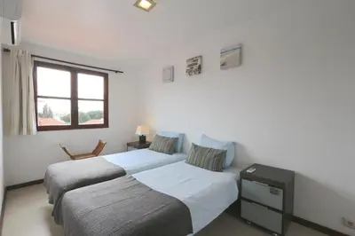a bedroom with two beds and a window at Vilar do Jardim 59 - Clever Details in Vilamoura