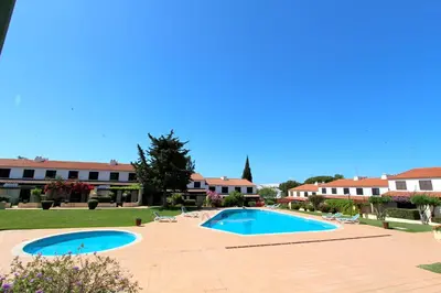 a resort with two swimming pools in a courtyard at Vilar do Jardim 59 - Clever Details in Vilamoura