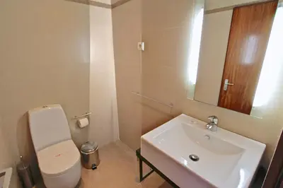 a bathroom with a sink and a toilet and a mirror at Vilar do Jardim 59 - Clever Details in Vilamoura
