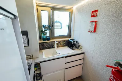 a small bathroom with a sink and a window at Casa do Sal in Albufeira